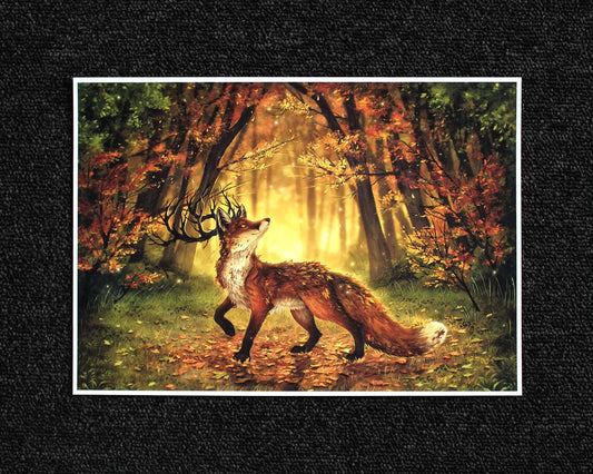 A4 print of a fantasy fox with antlers in an autumnal forest background with leaves on the ground